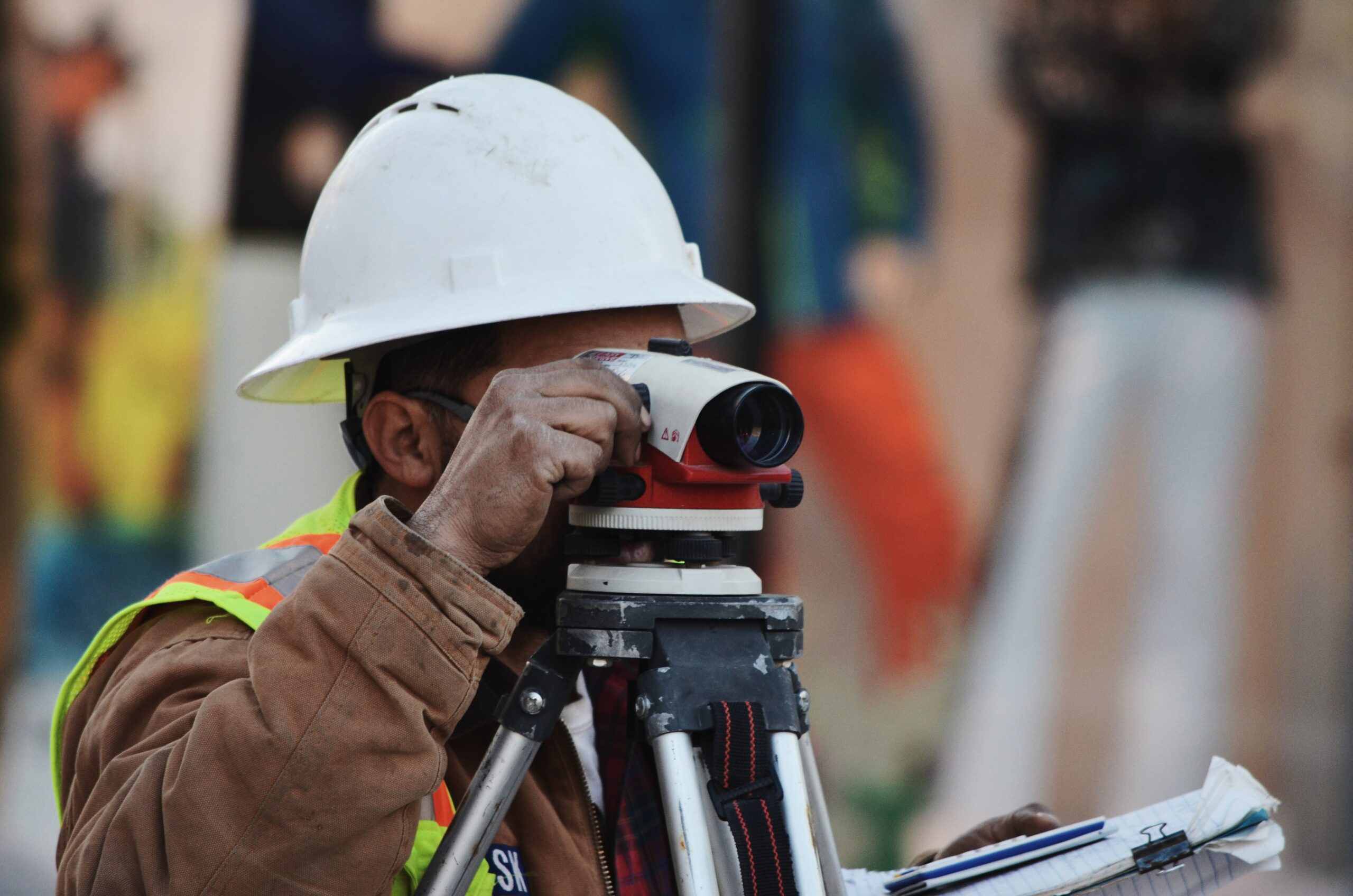 construction worker looking through a tool